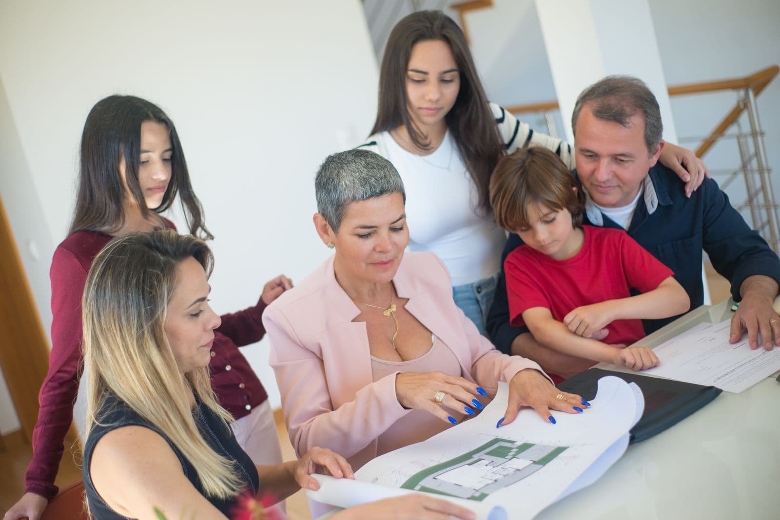 Three generations of a family reviewing home and financial plans together