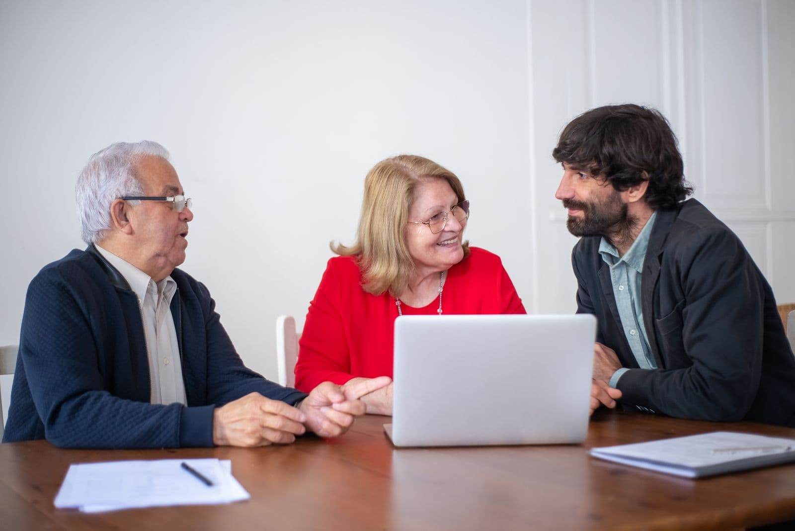 An elderly couple reviewing their financial plan with an advisor